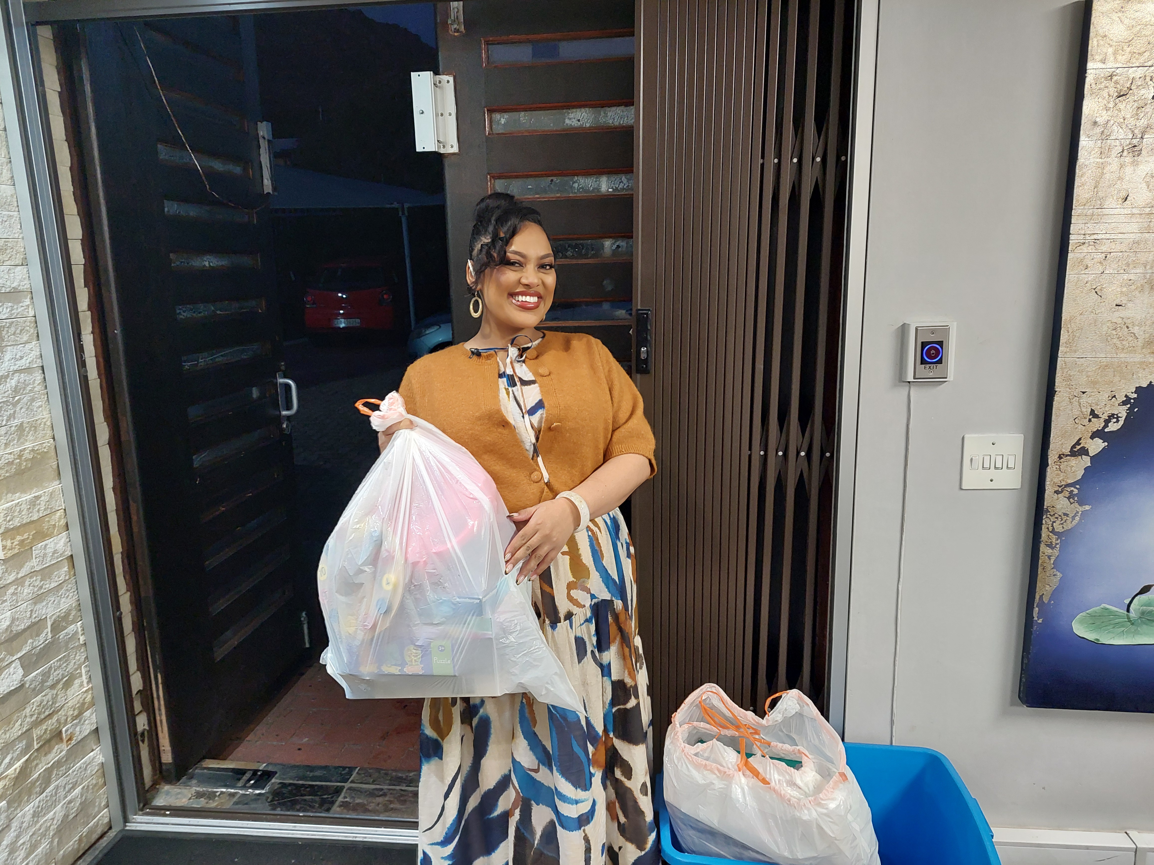 Expresso presenter handing over a bag of toys